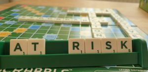 scrabble pieces spelling at risk