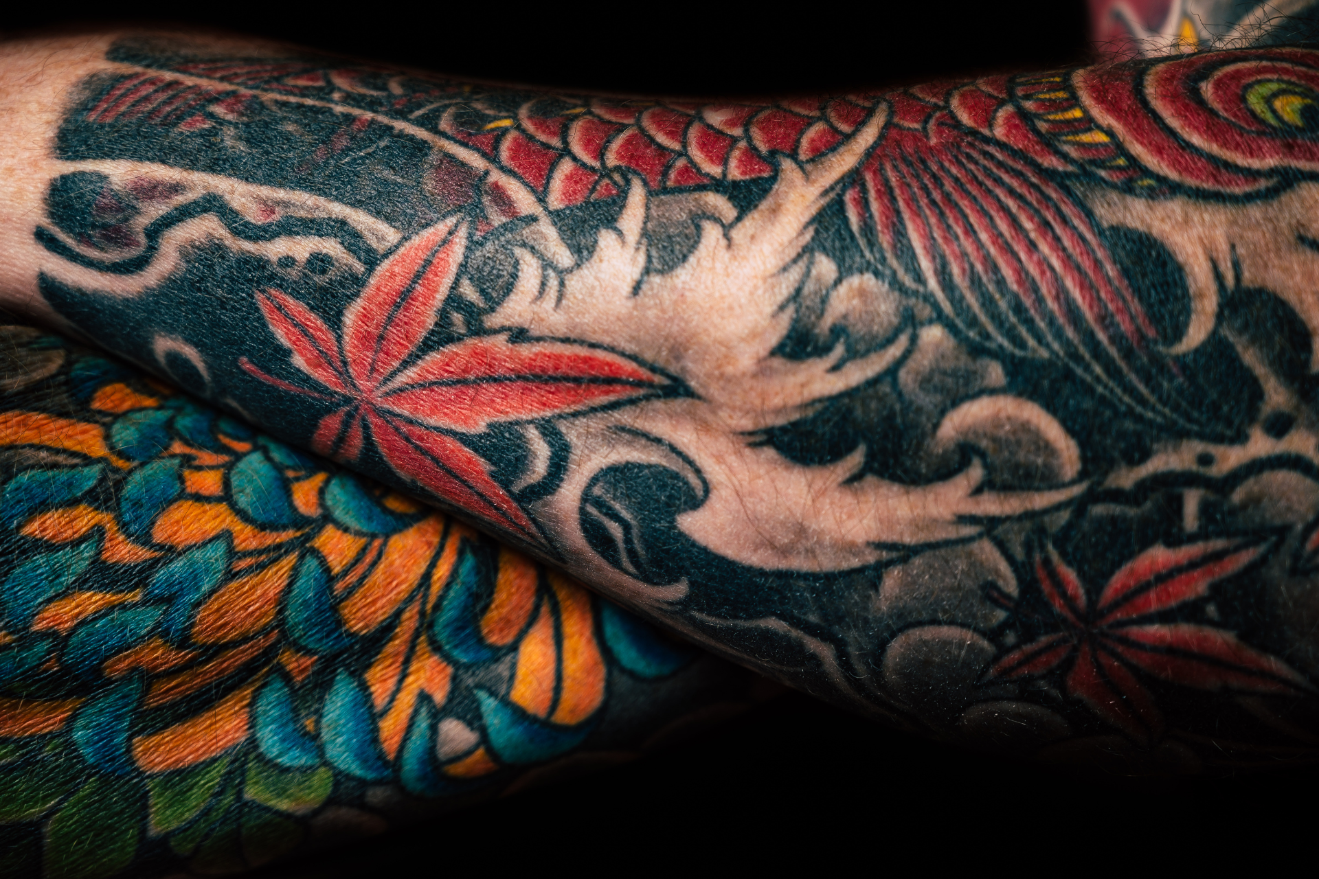 tattooed arms folded